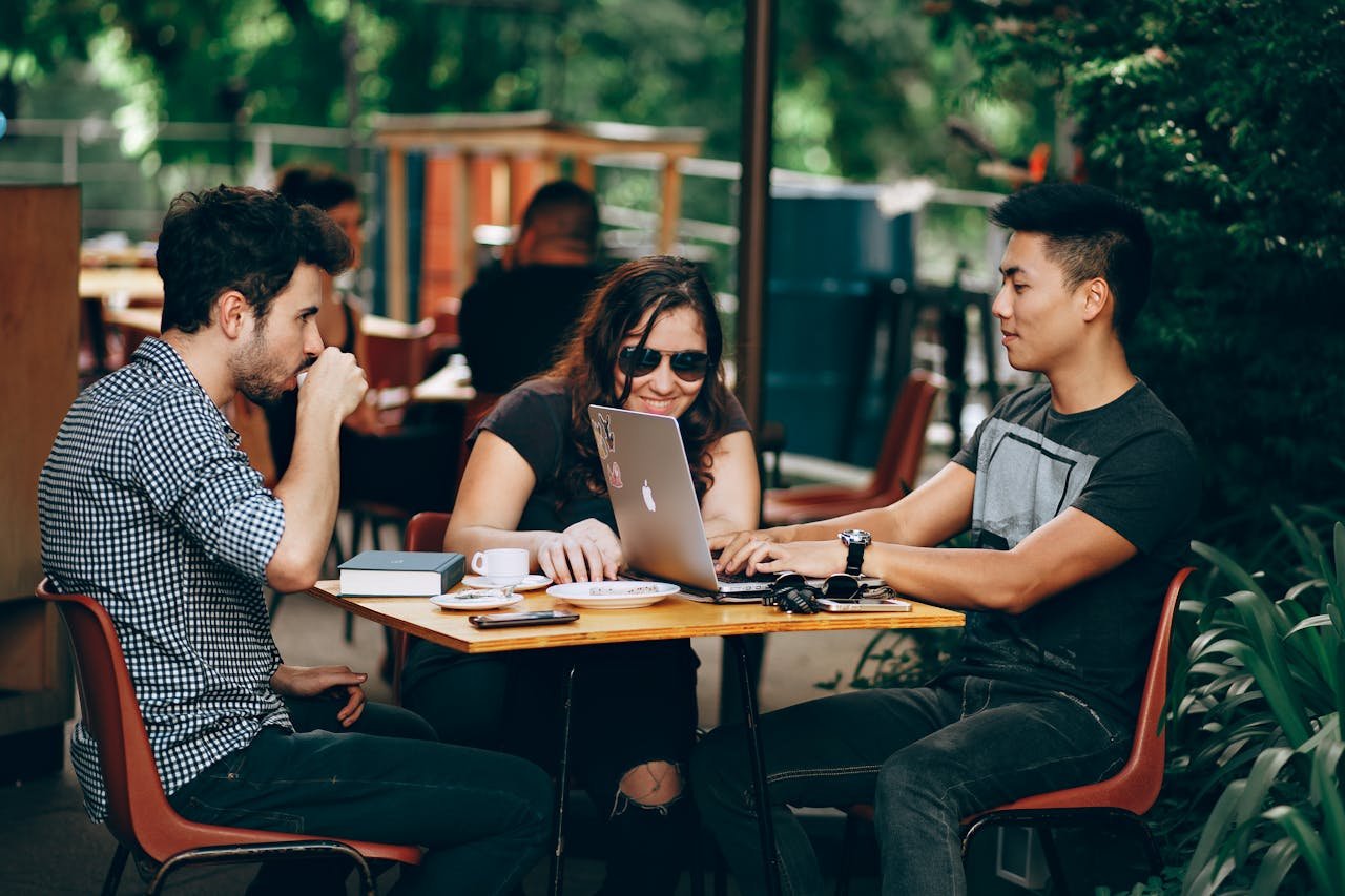 SBC Marketing London team members stay productive while working remotely from a local café, blending flexibility and creativity for success.